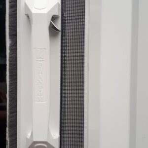 White door handle on a screen door.