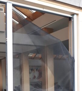 tornmesh-at-top-of-retractable-screen-door