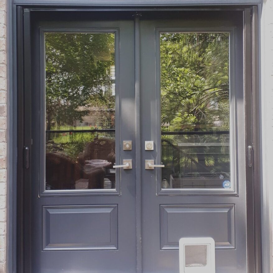 Black double doors with glass and pet door.