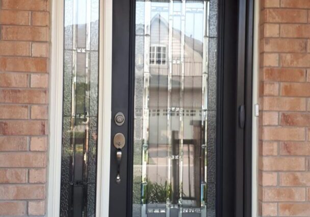 An elegant front entryway seamlessly incorporates modern retractable screen doors.